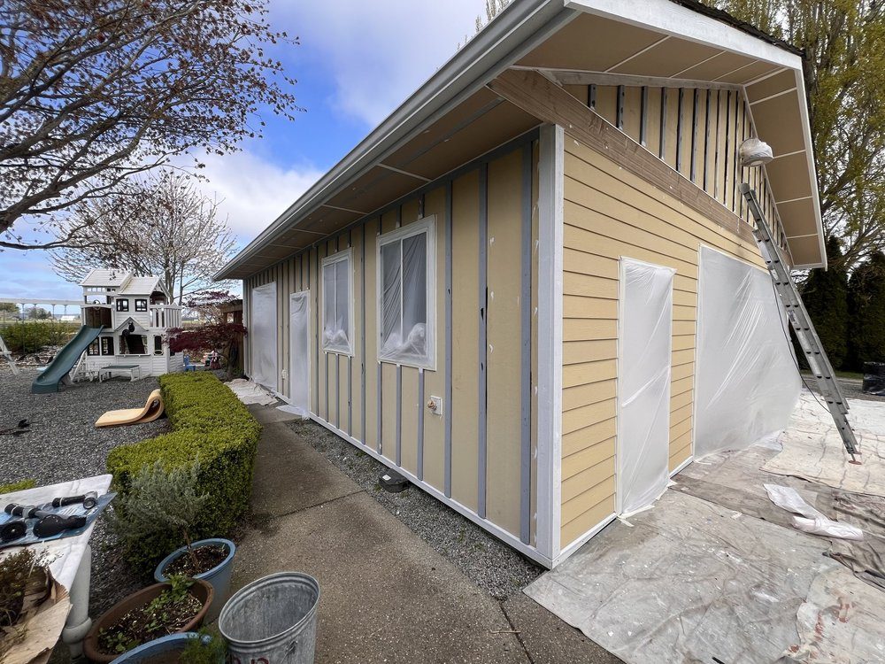Yellow garage exterior with white trim
